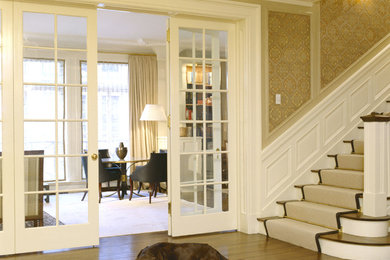 Inspiration for a large medium tone wood floor and brown floor foyer remodel in San Francisco with beige walls