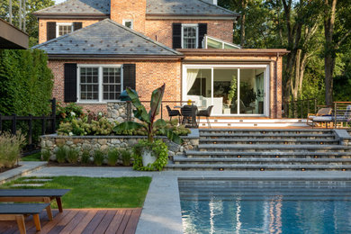 This is an example of a huge traditional partial sun side yard stone formal garden in New York.