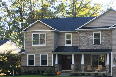 Example of a mid-sized arts and crafts brown two-story mixed siding exterior home design in Philadelphia with a mixed material roof