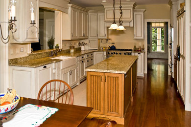 Transitional kitchen in New York with granite benchtops and with island.