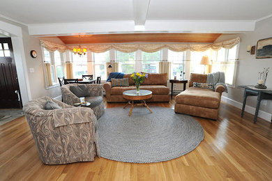 Inspiration for a large timeless open concept and formal medium tone wood floor and brown floor living room remodel in Boston with gray walls, no fireplace and no tv