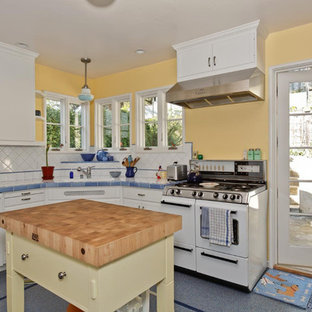 Inspiration for a mid-sized eclectic l-shaped kitchen pantry in San Francisco with shaker cabinets, blue cabinets, tile benchtops, white splashback, ceramic splashback, white appliances, terrazzo floors, with island and blue floor.