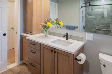 Bathroom - small 1960s 3/4 green tile and porcelain tile porcelain tile, beige floor and single-sink bathroom idea in New York with furniture-like cabinets, medium tone wood cabinets, a two-piece toilet, green walls, an undermount sink, quartz countertops, white countertops, a niche and a built-in vanity