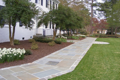 Example of a classic white brick gable roof design in Other