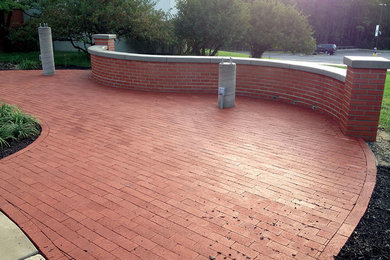 Example of a mid-sized classic front yard brick patio design in Philadelphia with no cover