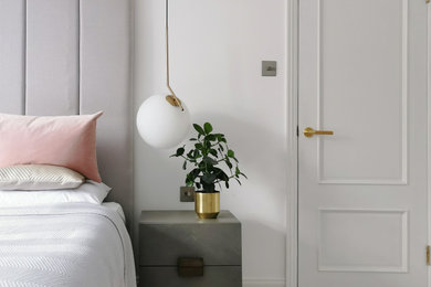 Design ideas for a large modern master and grey and pink bedroom in London with white walls, carpet and white floors.