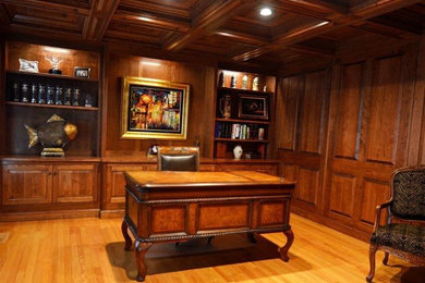 Inspiration for a mid-sized timeless medium tone wood floor study room remodel in Boston
