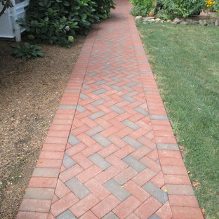 Photo of a mid-sized traditional backyard patio in New York with brick pavers.