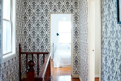 Design ideas for a mid-sized traditional hallway in Sydney with black walls and light hardwood floors.