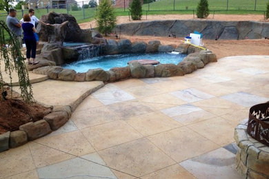 Travertine look concrete patio, Rock firepit, Retaining wall, pool and spa