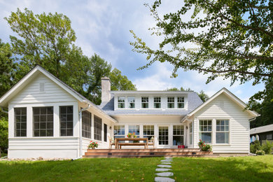 Coastal two-story house exterior idea in Minneapolis with a shingle roof and a blue roof