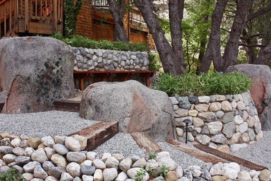 This is an example of a traditional front yard gravel retaining wall landscape.
