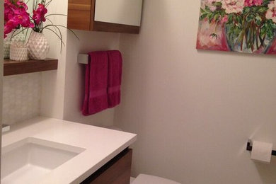 Inspiration for a small modern master white tile and mosaic tile marble floor alcove shower remodel in Ottawa with flat-panel cabinets, medium tone wood cabinets, a one-piece toilet, white walls, an undermount sink and quartz countertops