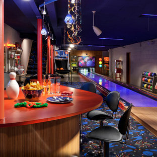 Large eclectic basement in Milwaukee with carpet and multi-coloured floors.