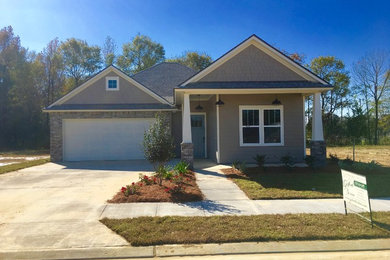 Example of a mid-sized country one-story concrete fiberboard exterior home design with a shingle roof