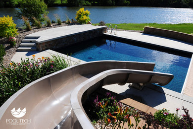 Water slide - mid-sized traditional backyard concrete and rectangular water slide idea in Other