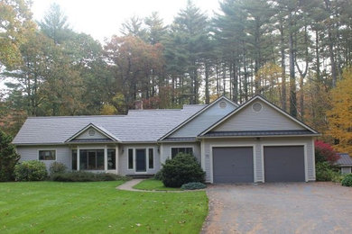 Large traditional beige one-story wood gable roof idea in Boston
