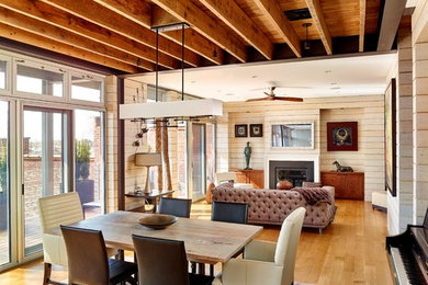 Inspiration for a mid-sized contemporary open plan dining in Philadelphia with light hardwood floors, a standard fireplace and a wood fireplace surround.