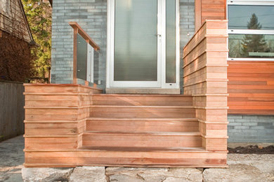 Design ideas for a small modern front yard verandah in Toronto with decking.