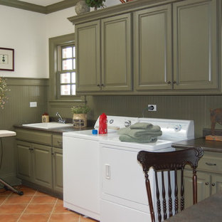 Design ideas for a classic utility room in Chicago with a built-in sink, raised-panel cabinets, green cabinets, a side by side washer and dryer, terracotta flooring, red floors and white walls.