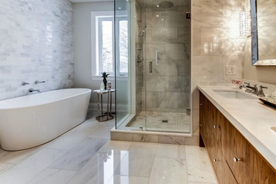 Mid-sized trendy master marble floor and gray floor bathroom photo in Toronto with flat-panel cabinets, dark wood cabinets, a one-piece toilet, gray walls, an undermount sink, quartzite countertops and a hinged shower door