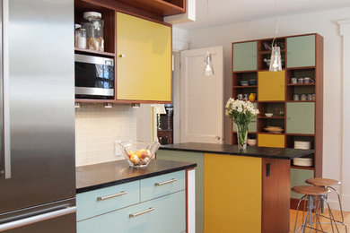 Eat-in kitchen - modern light wood floor eat-in kitchen idea in New York with flat-panel cabinets, blue cabinets, white backsplash, glass tile backsplash and an island
