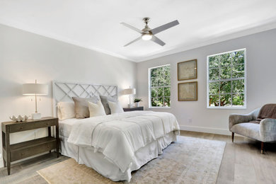 This is an example of a transitional master bedroom in Miami.