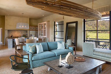 Example of a large cottage open concept light wood floor and multicolored floor living room design in San Francisco with beige walls, a standard fireplace, a metal fireplace and a wall-mounted tv
