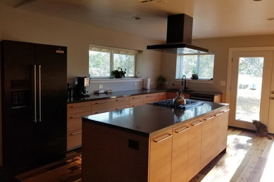 Mid-sized minimalist l-shaped medium tone wood floor and brown floor open concept kitchen photo in Other with an undermount sink, flat-panel cabinets, beige cabinets, quartz countertops, black appliances, an island and gray countertops