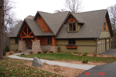 Example of a large mountain style green two-story mixed siding exterior home design in Minneapolis