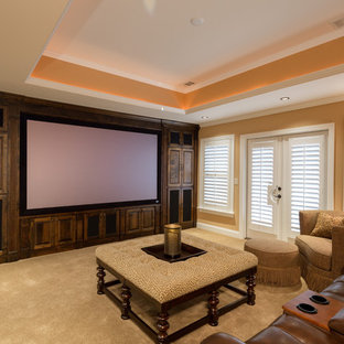 Inspiration for a large classic open plan home cinema in Atlanta with orange walls, carpet and a projector screen.