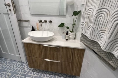 Contemporary bathroom in Sydney with medium wood cabinets, white tile, white walls, porcelain floors, engineered quartz benchtops, white benchtops, a single vanity and a floating vanity.