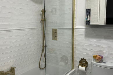 Inspiration for a contemporary white tile and ceramic tile ceramic tile and multicolored floor bathroom remodel in Dublin with a one-piece toilet, white walls and a hinged shower door