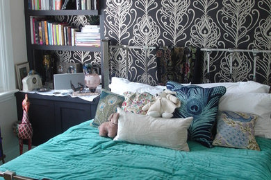 Mid-sized eclectic master bedroom in London with black walls, carpet and no fireplace.