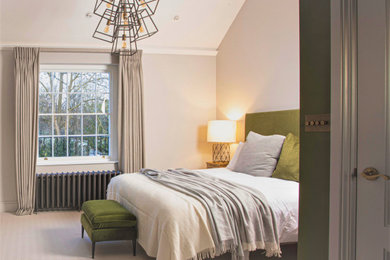 Design ideas for a large transitional master bedroom in London.