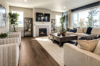 Inspiration for a large timeless formal and enclosed laminate floor and brown floor living room remodel in Seattle with beige walls, a standard fireplace, a tile fireplace and a wall-mounted tv