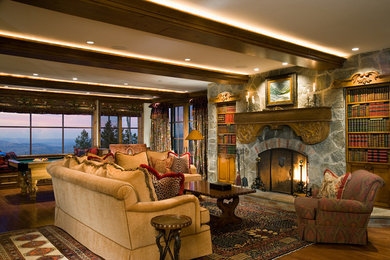 Elegant medium tone wood floor family room photo in Salt Lake City with a standard fireplace and a stone fireplace
