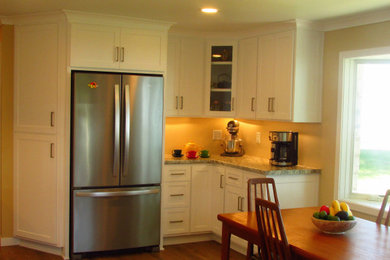 Eat-in kitchen - eat-in kitchen idea in Other with shaker cabinets, white cabinets and laminate countertops