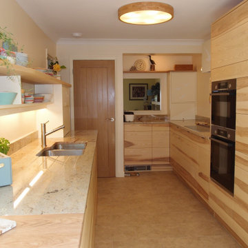 Galley kitchen in Ash with carvings