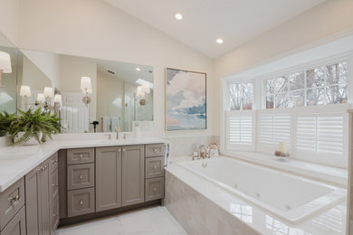 Transitional master ceramic tile ceramic tile, beige floor and double-sink bathroom photo in DC Metro with recessed-panel cabinets, gray cabinets, white walls, an undermount sink, quartz countertops, a hinged shower door, white countertops and a built-in vanity