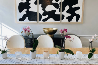 Example of a mid-sized danish medium tone wood floor and brown floor enclosed dining room design in Los Angeles with gray walls