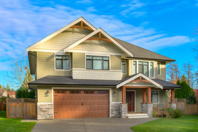 Example of a trendy two-story house exterior design in Vancouver with a shingle roof