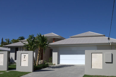 Design ideas for a large contemporary one-storey concrete grey exterior in Sunshine Coast with a hip roof.