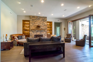 Living room - huge craftsman formal and enclosed medium tone wood floor and gray floor living room idea in Orange County with a standard fireplace, a stone fireplace, no tv and gray walls