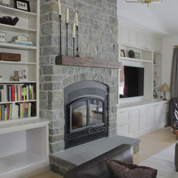 Custom-built entertainment center, white inset cabinetry and flat gold hardware.