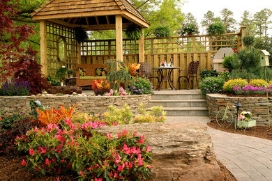 Inspiration for a mid-sized rustic full sun backyard stone retaining wall landscape in Other for spring.