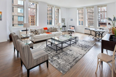 Inspiration for a large contemporary formal and loft-style medium tone wood floor living room remodel in New York with white walls and a wall-mounted tv