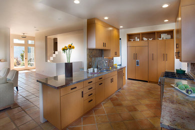 Example of a large trendy eat-in kitchen design in San Francisco with light wood cabinets and a peninsula