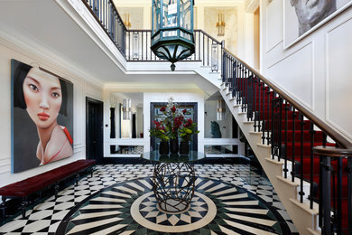 Large contemporary foyer in Oxfordshire with white walls and marble floors.