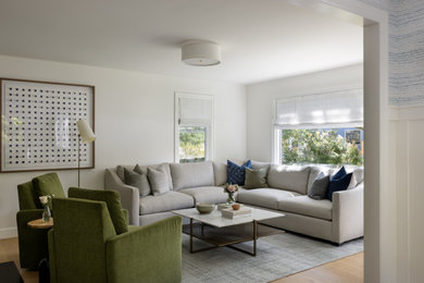 Living room - mid-sized transitional formal and enclosed light wood floor and brown floor living room idea in Seattle with white walls